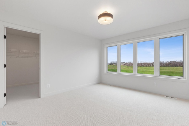 5820 31st St S, Fargo, ND 58104 - unfurnished bedroom with carpet, a spacious closet, and a closet