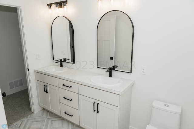 bathroom featuring vanity and toilet