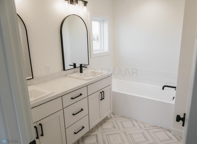 bathroom featuring a tub to relax in and vanity