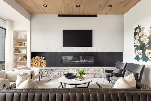 living room featuring built in shelves, wooden ceiling, and a brick fireplace