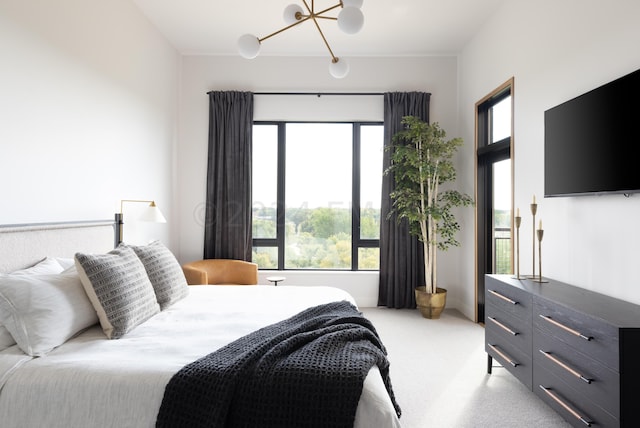 carpeted bedroom featuring a chandelier