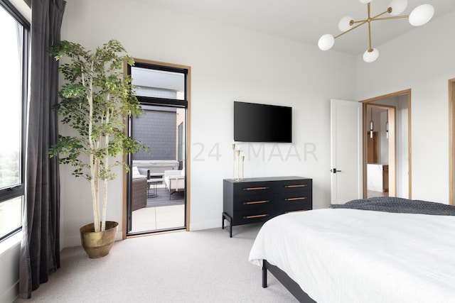 carpeted bedroom with an inviting chandelier