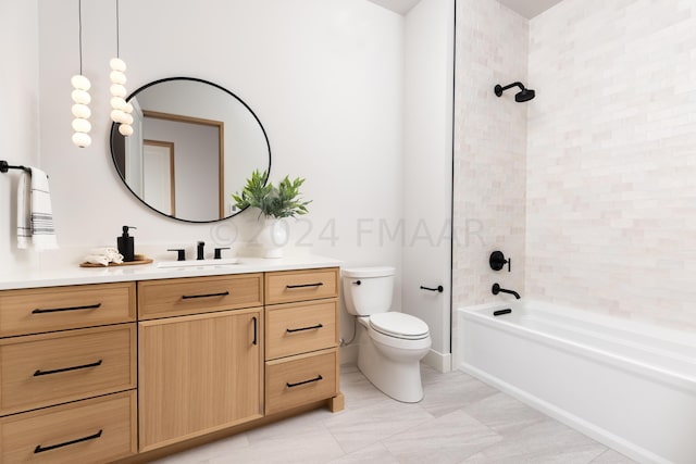 full bathroom featuring vanity, tiled shower / bath combo, and toilet