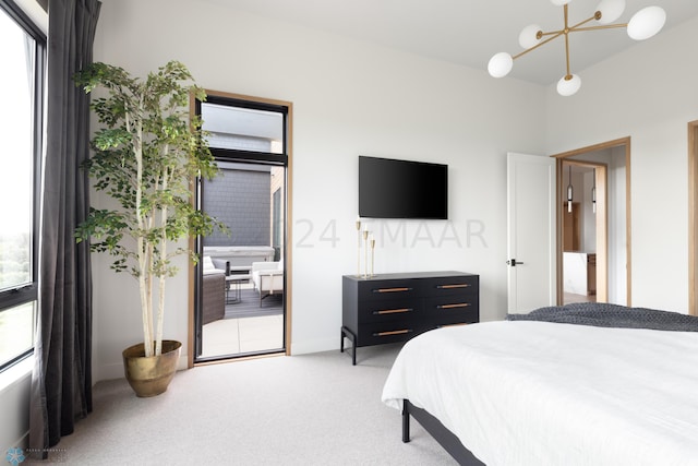 bedroom with light colored carpet and a chandelier