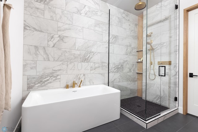 bathroom featuring plus walk in shower, tile patterned floors, and tile walls