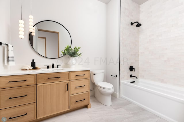 full bathroom with vanity, toilet, and tiled shower / bath