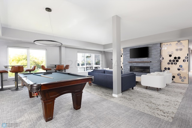 rec room with a large fireplace, light carpet, plenty of natural light, and billiards