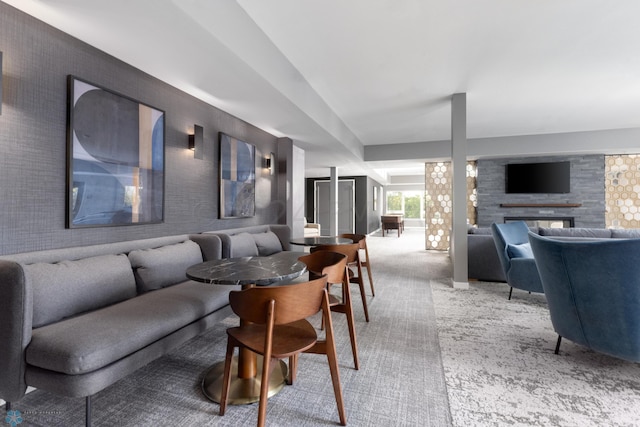 living room featuring a multi sided fireplace and light colored carpet