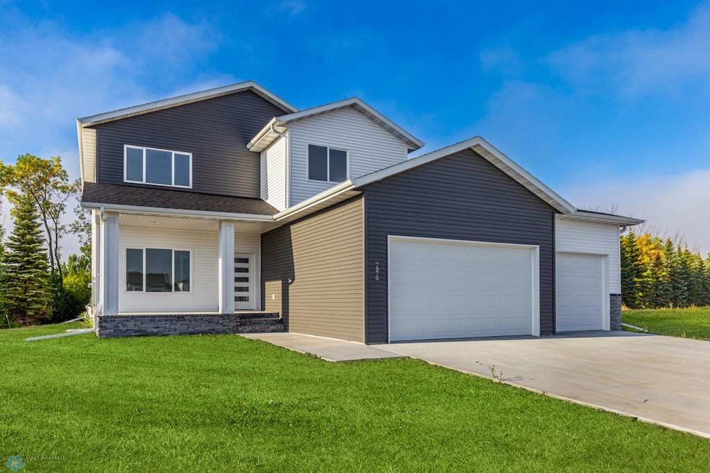 view of front of property with a garage and a front yard