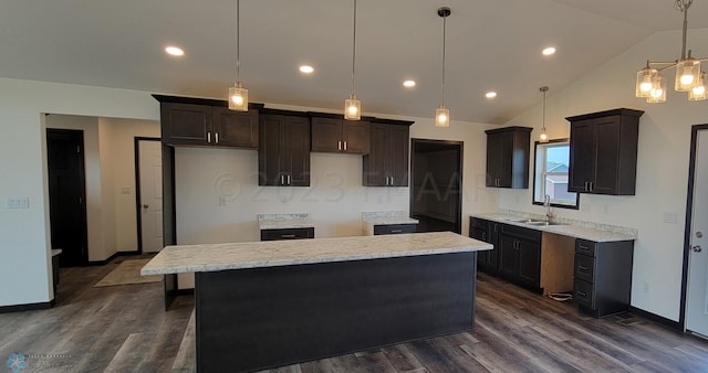 kitchen with sink, a kitchen island, pendant lighting, and lofted ceiling