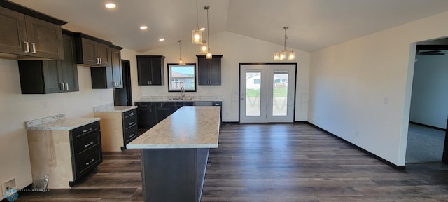 kitchen featuring dark hardwood / wood-style flooring, dark brown cabinetry, sink, pendant lighting, and a center island