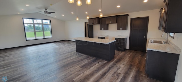 kitchen with a center island, sink, ceiling fan, dark hardwood / wood-style floors, and decorative light fixtures