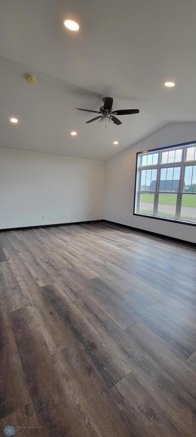 spare room featuring hardwood / wood-style flooring, ceiling fan, and vaulted ceiling