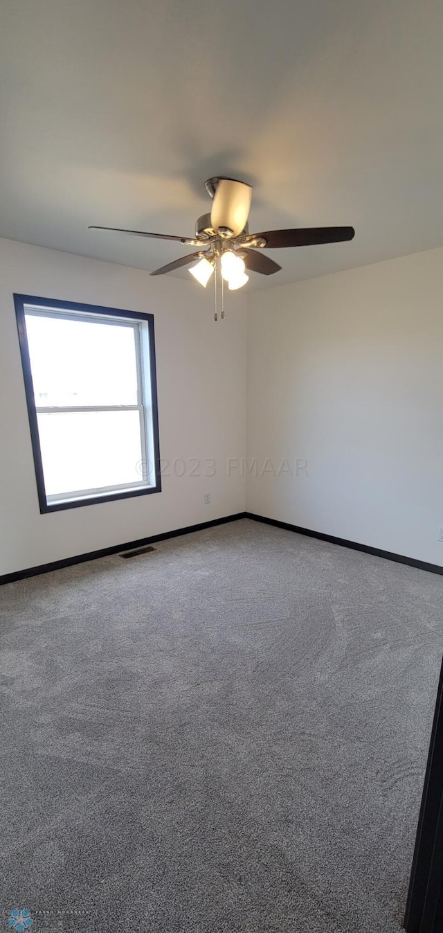 unfurnished room featuring carpet floors and ceiling fan