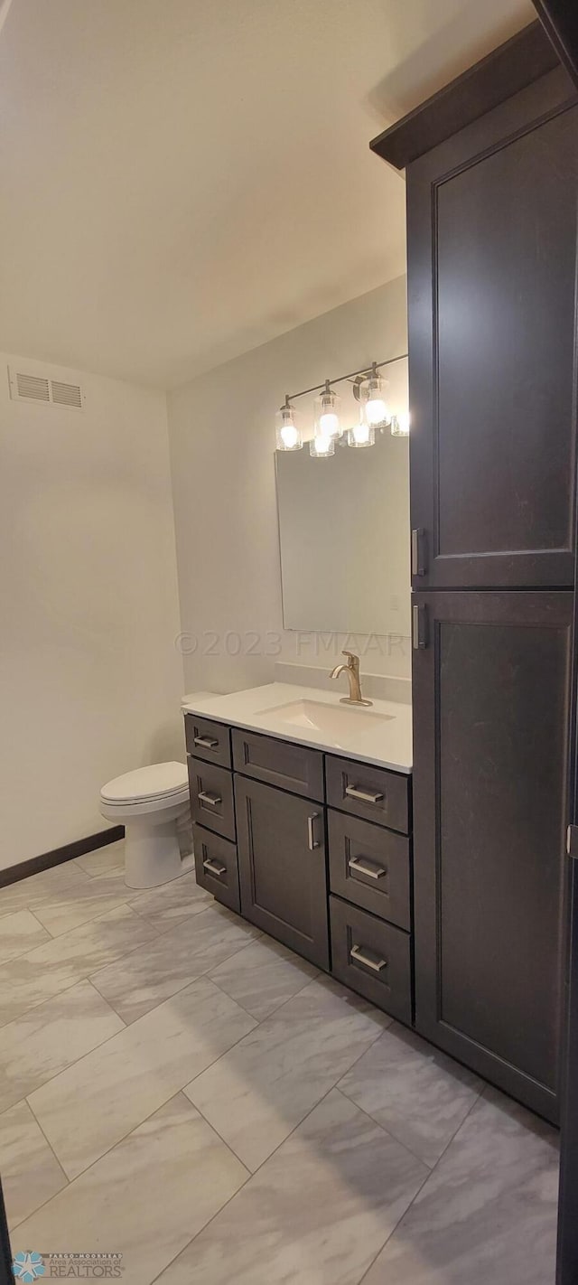 bathroom featuring vanity and toilet