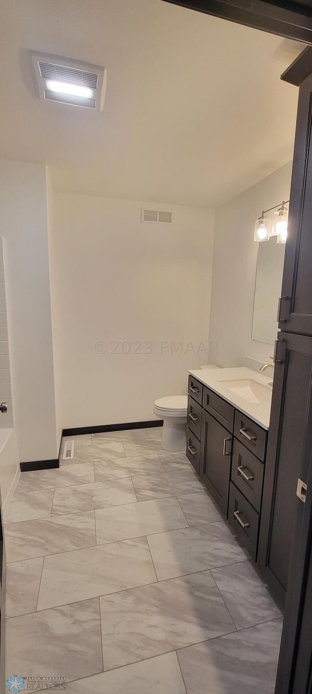 bathroom with vanity and toilet