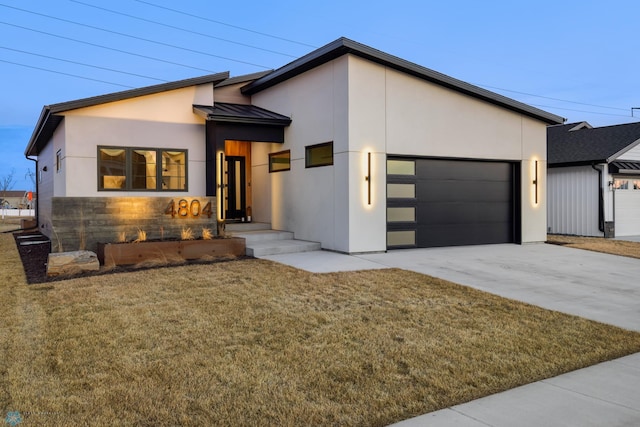 view of front of house with a garage and a front lawn