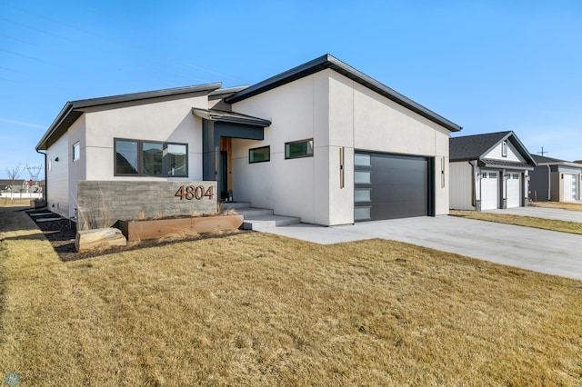 view of front of property with a garage and a front yard