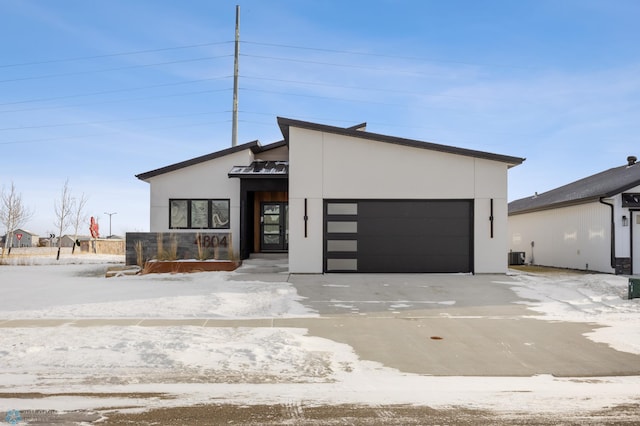 contemporary home with a garage and central AC