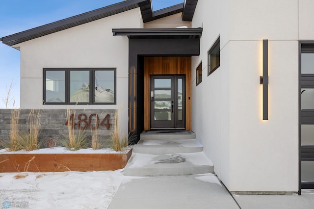 view of snow covered property entrance