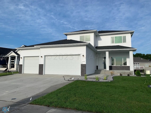 view of front of property with a garage and a front yard