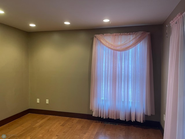 empty room with hardwood / wood-style floors