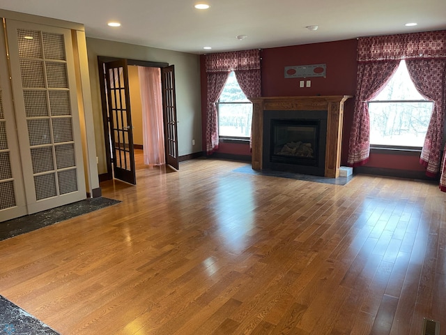 unfurnished living room with hardwood / wood-style floors