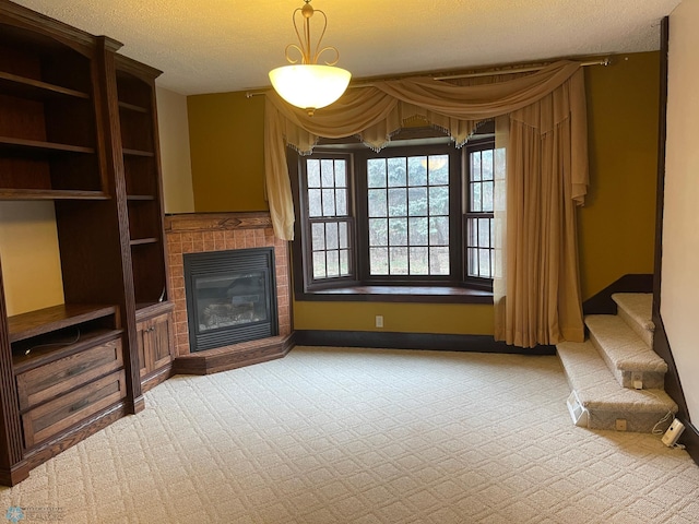 unfurnished living room with carpet and a textured ceiling