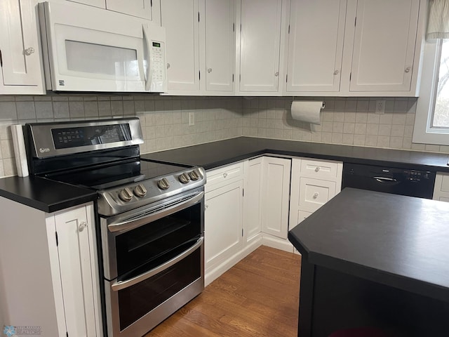 kitchen with hardwood / wood-style floors, dishwasher, double oven range, backsplash, and white cabinets