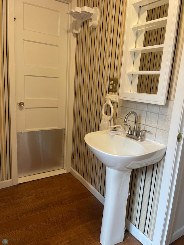 bathroom with wood-type flooring and tasteful backsplash