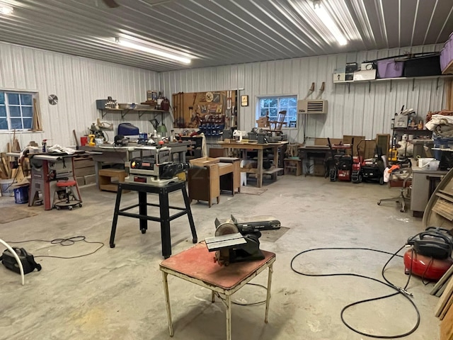 garage with a wall unit AC and a workshop area