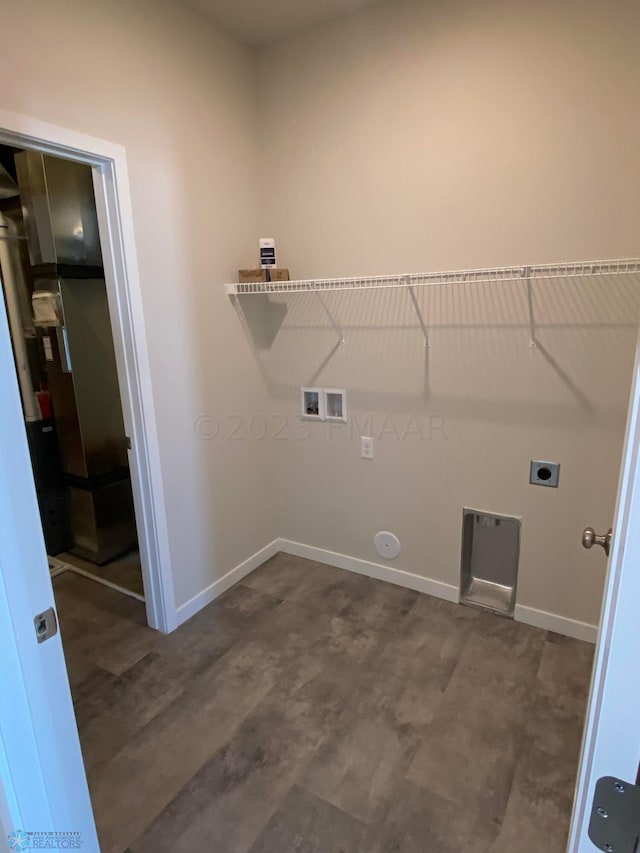 clothes washing area with hookup for an electric dryer, gas dryer hookup, and hookup for a washing machine