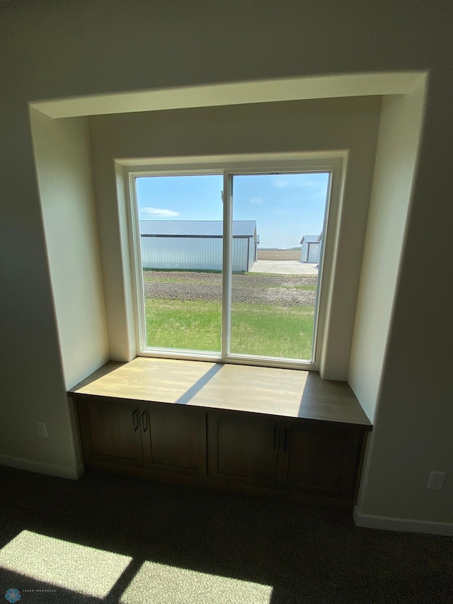 doorway featuring baseboards