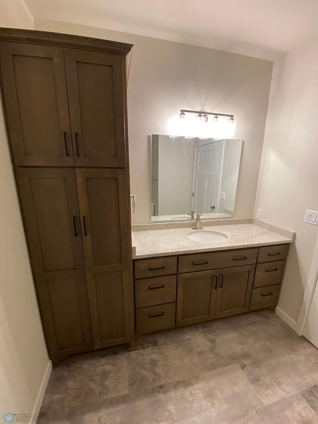 bathroom with baseboards and vanity