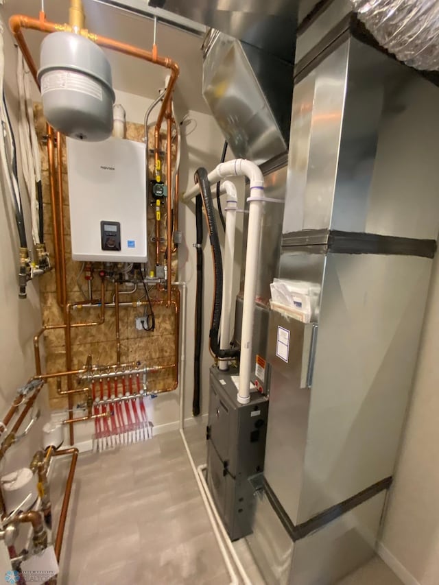 utility room featuring tankless water heater and heating unit