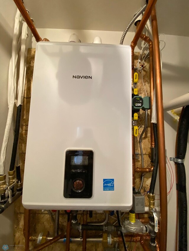 utility room featuring water heater