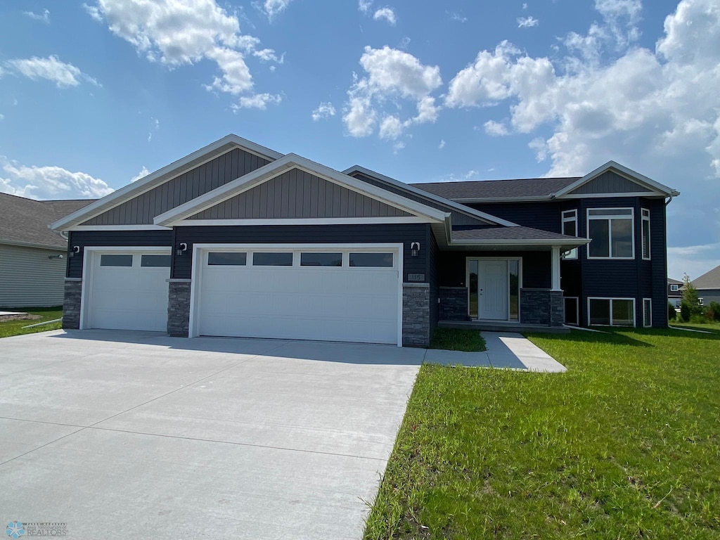 view of front of property with a garage and a front yard