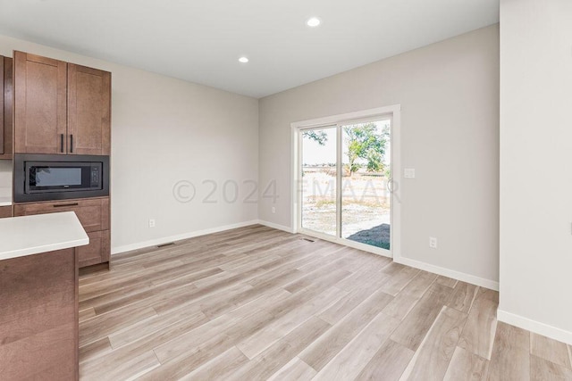 unfurnished living room featuring light hardwood / wood-style flooring