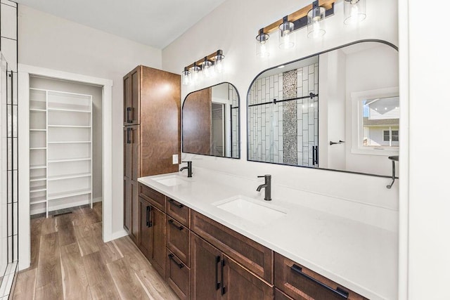 bathroom featuring wood-type flooring and double sink vanity