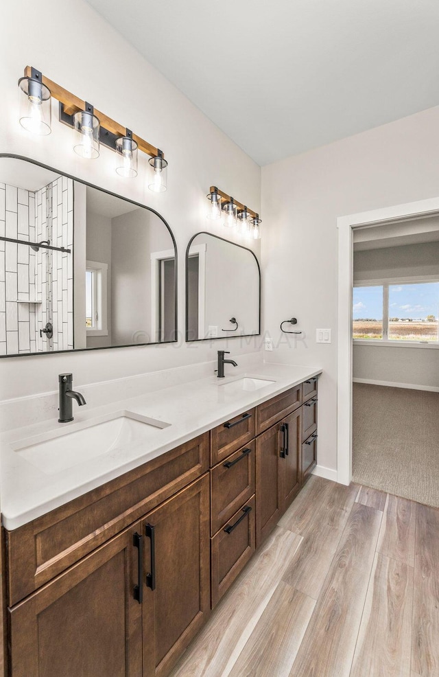 bathroom with hardwood / wood-style flooring and double sink vanity