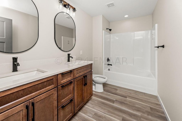 full bathroom featuring shower / bath combination, toilet, wood-type flooring, and double sink vanity