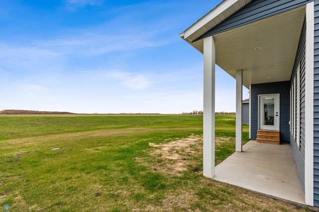 view of yard featuring a rural view and entry steps