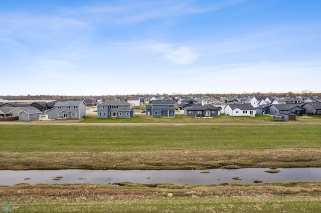 view of property's community with a residential view and a lawn