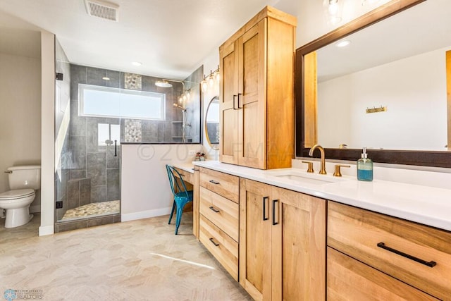 bathroom with visible vents, a shower stall, toilet, and vanity