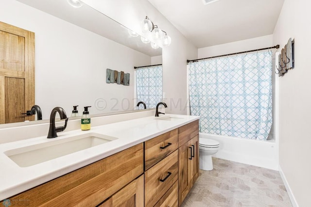 bathroom featuring a sink, shower / tub combo, toilet, and double vanity