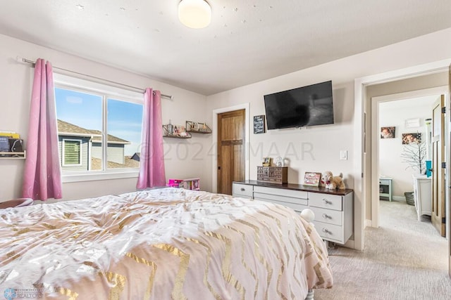 bedroom featuring light colored carpet and baseboards