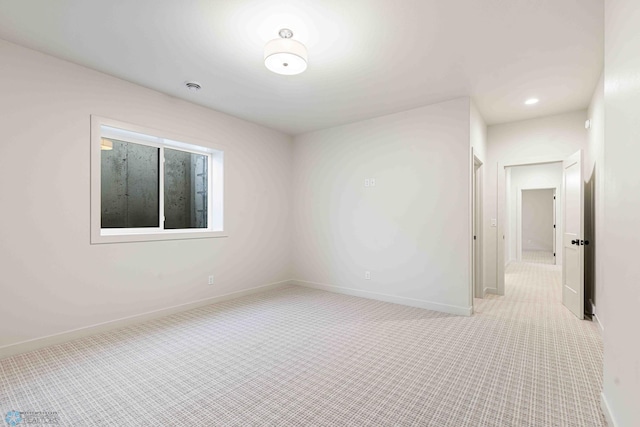 unfurnished room featuring baseboards and carpet floors