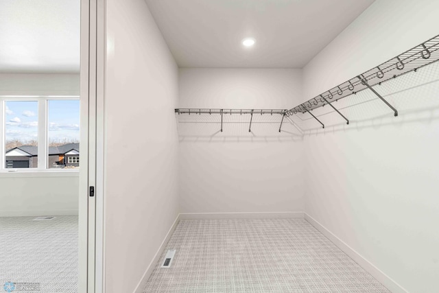spacious closet featuring visible vents and carpet