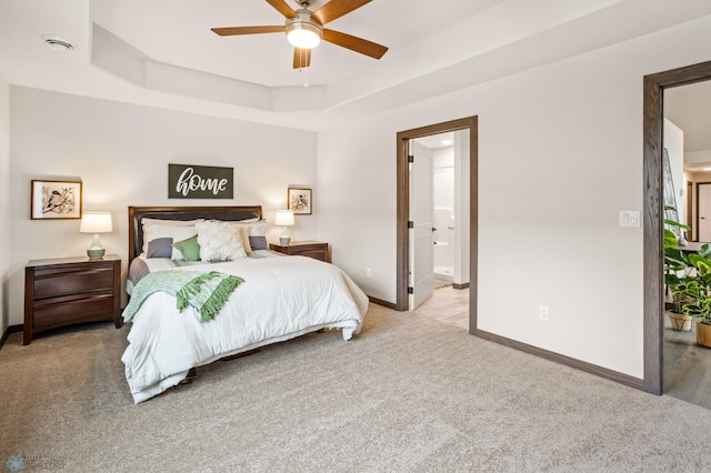 bedroom featuring ensuite bathroom, ceiling fan, and light colored carpet