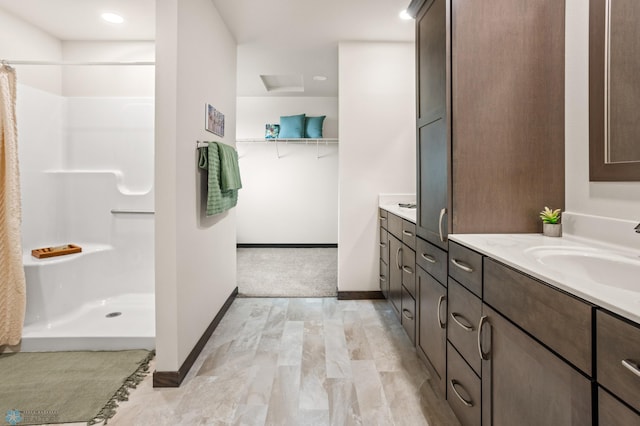 bathroom with vanity and a shower